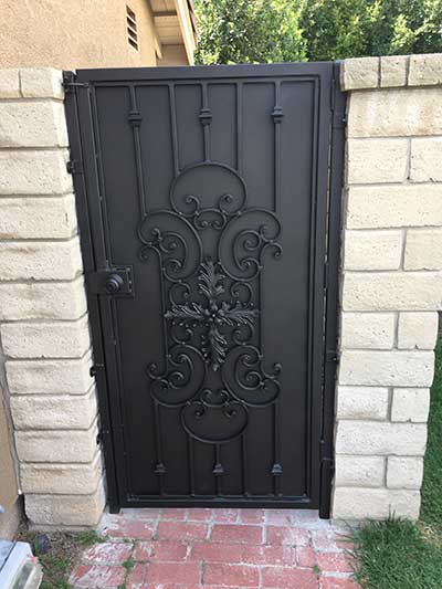 Wrought Iron Gate Conected to Masonry Wall